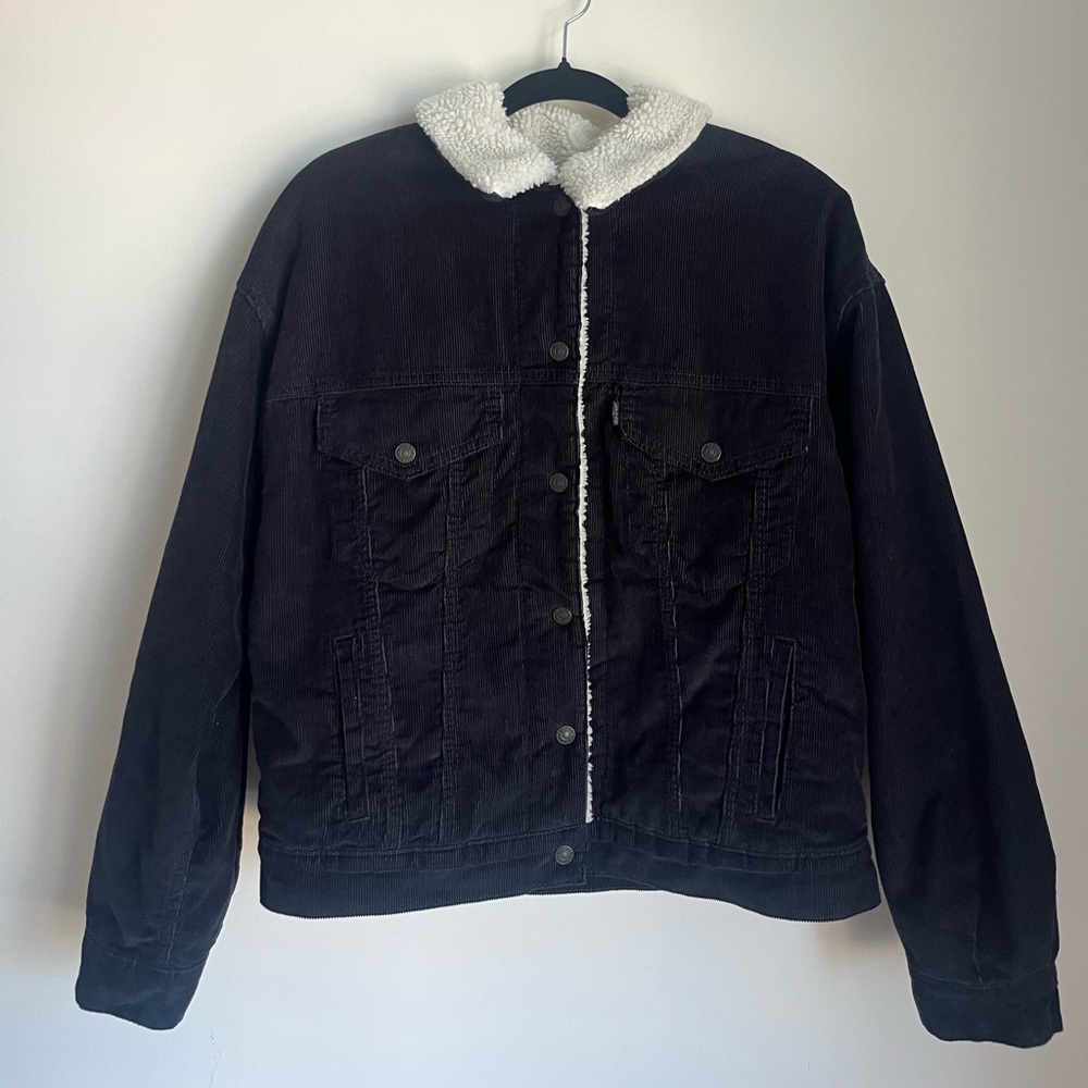 Never worn.Levi's Black Trucker Jacket with Cream Sherpa Lining!